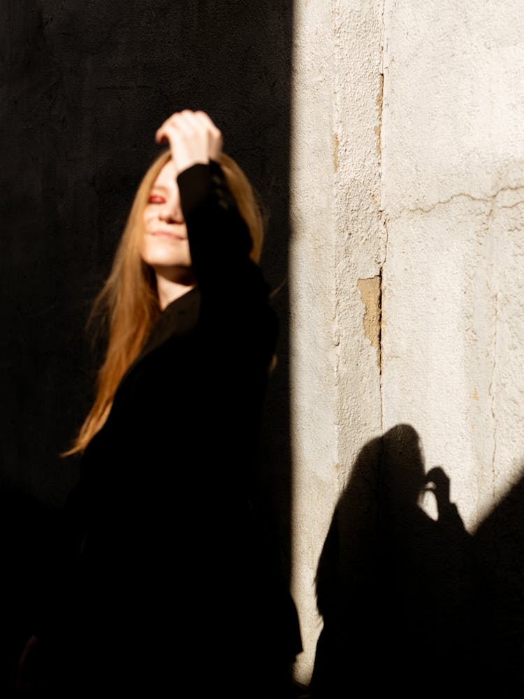 Woman Hiding In Shade From Sunlight