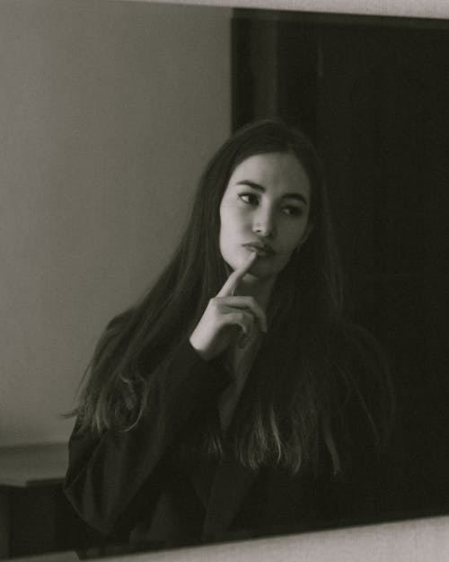 Free Grayscale Photo of a Woman in Front of Mirror Stock Photo