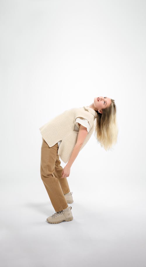 Free Woman in White Long Sleeve Shirt and Brown Pants Stock Photo