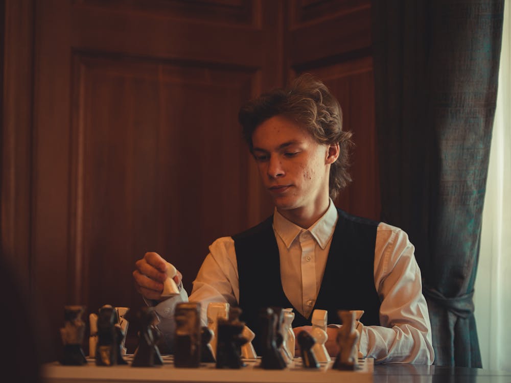 Handsome Male Model Considers His Next Chess Move Stock Photo - Download  Image Now - Chess, Chess Piece, Contemplation - iStock