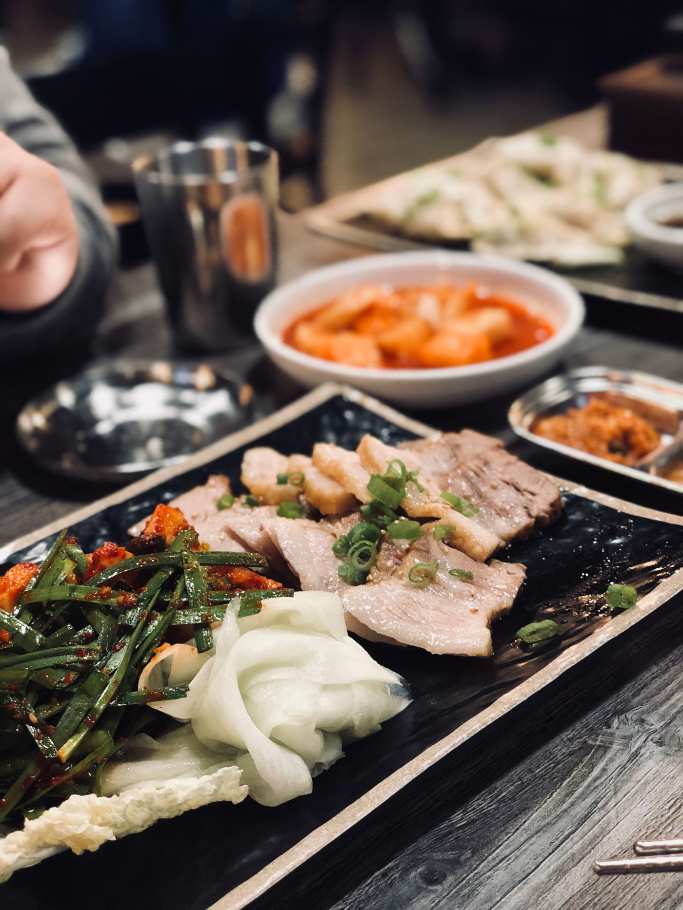 Korean barbecue with fresh vegetables and side dishes on a table