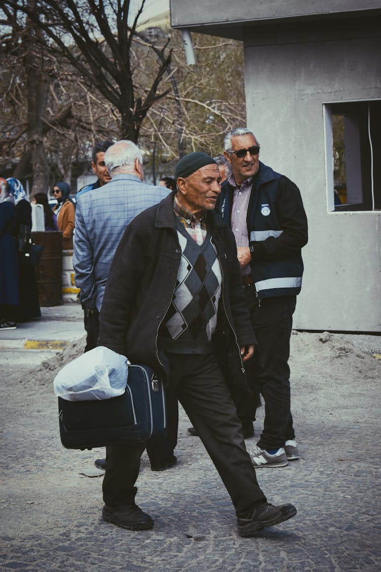 A Man Carrying A Bag