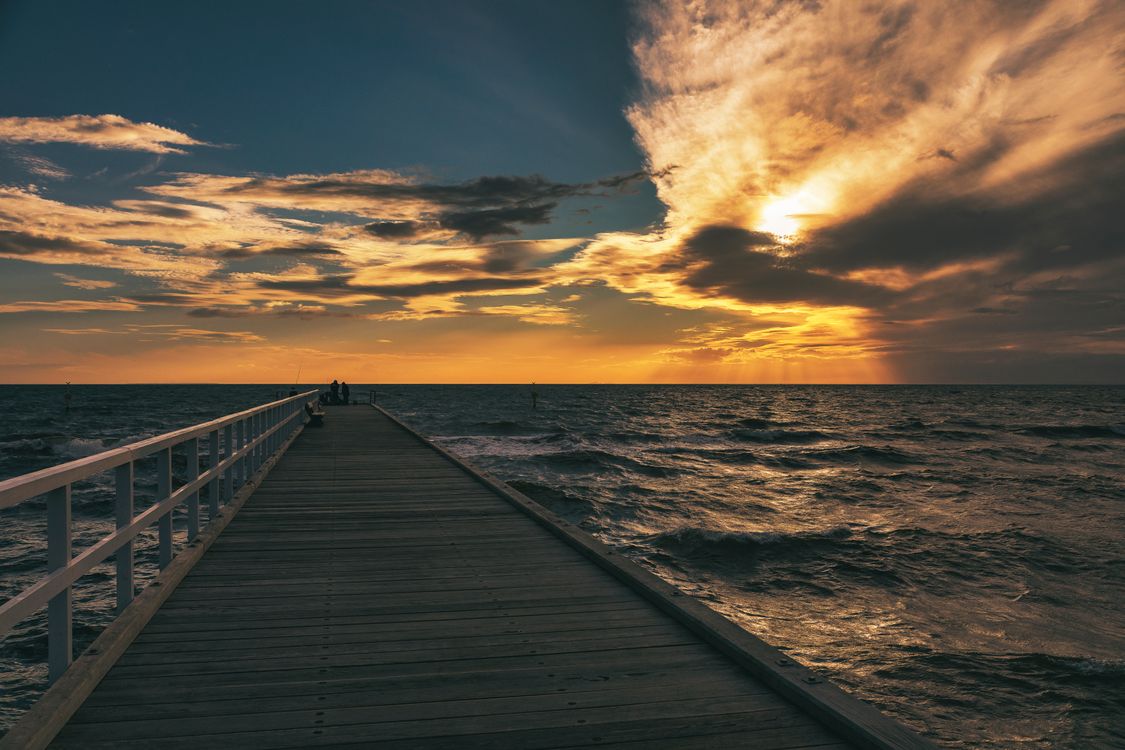 Pier in Sea under Dramatic Sky at Sunset · Free Stock Photo