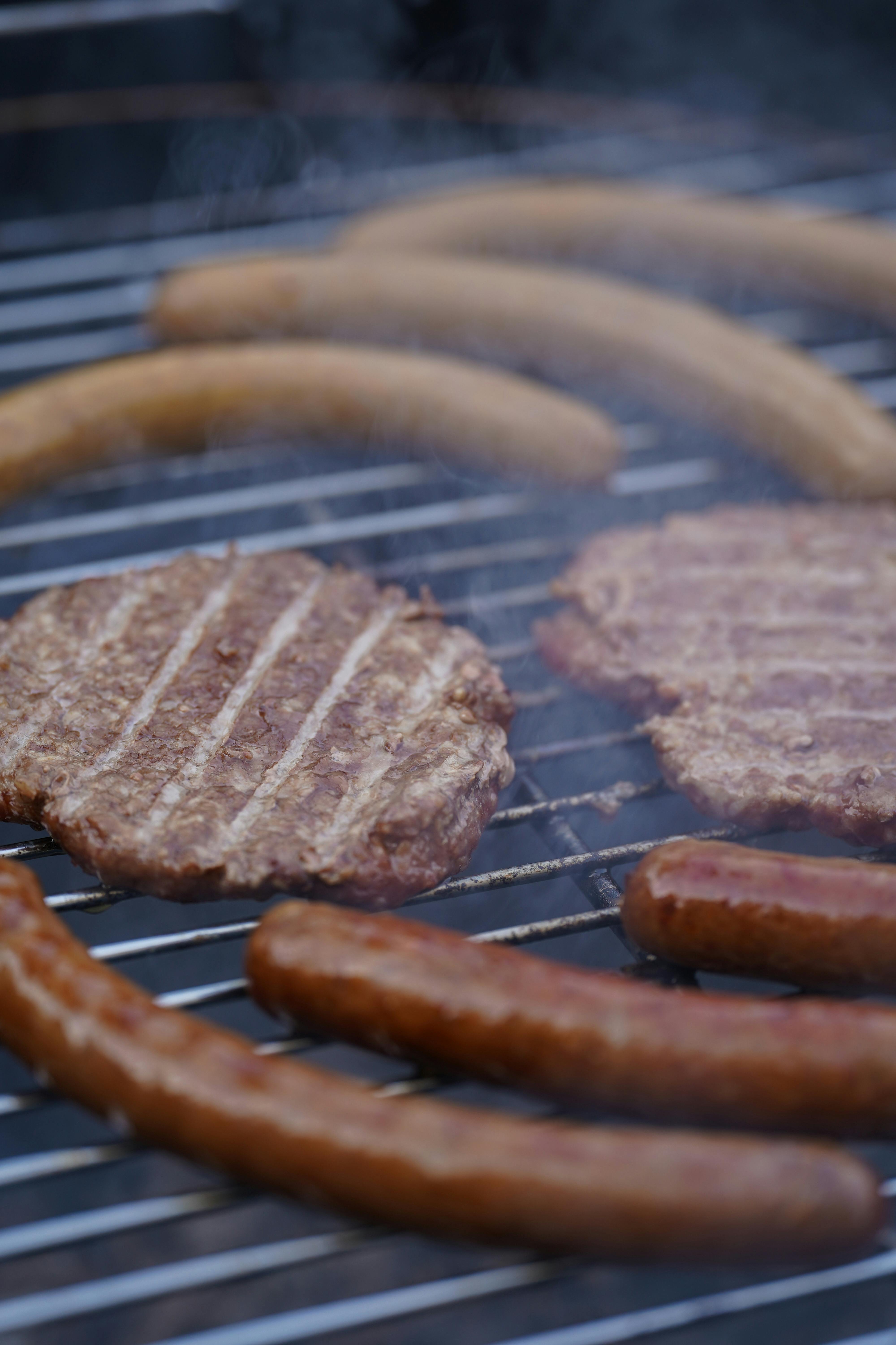 Burger Patties and Sausages on a Grill · Free Stock Photo