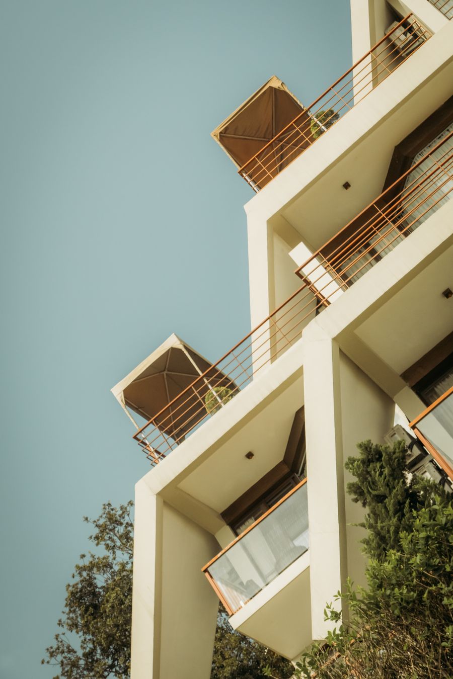Residence tower with private balconies against a blue sky