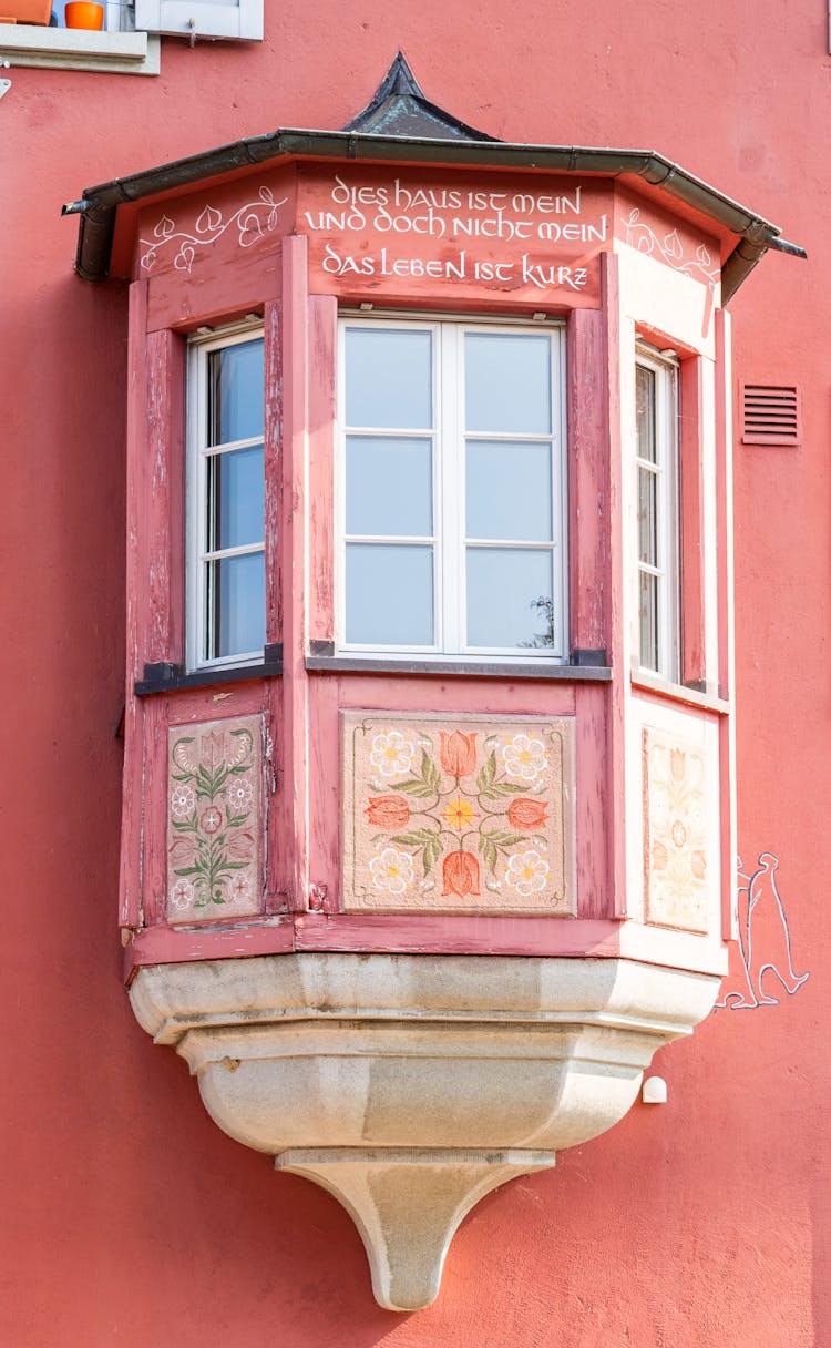 Colorful Hand Painted Pink Or Soft Red Bay Window With Sentence In German - This House Is Mine But It Is Not Mine, Life Is Short. Stein Am Rhein In Switzerland