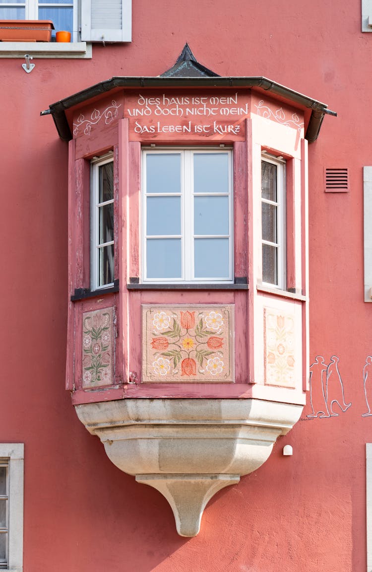 Colorful Hand Painted Pink Or Soft Red Bay Window With Sentence In German - This House Is Mine But It Is Not Mine, Life Is Short. Stein Am Rhein In Switzerland