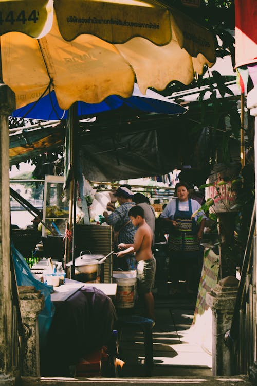 Boy Cooks in Front of Stove Outdoors