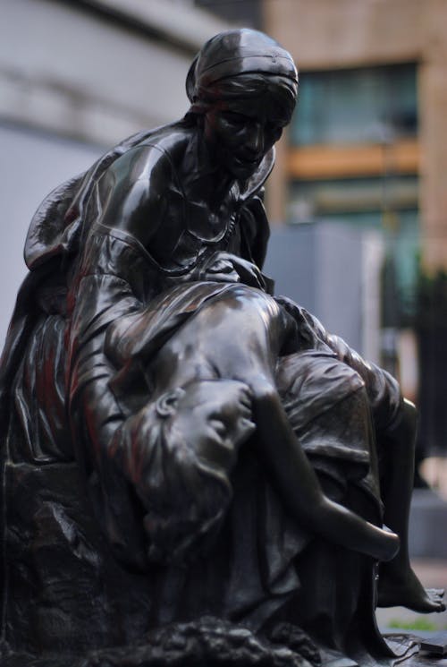 Black Statue of a Woman Holding a Boy