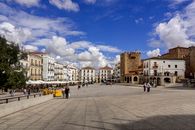 Scenic view of Plaza Mayor in Cáceres, featuring historic buildings and a vibrant urban atmosphere.