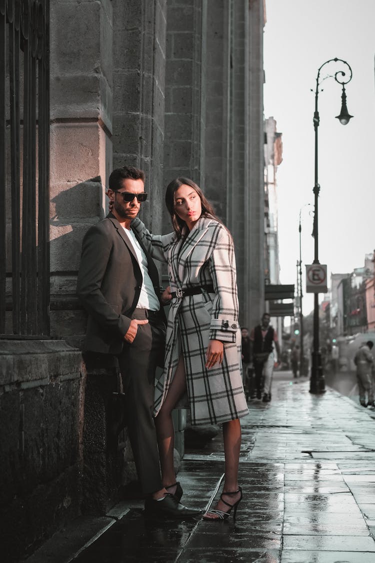 Couple Standing On Sidewalk In City