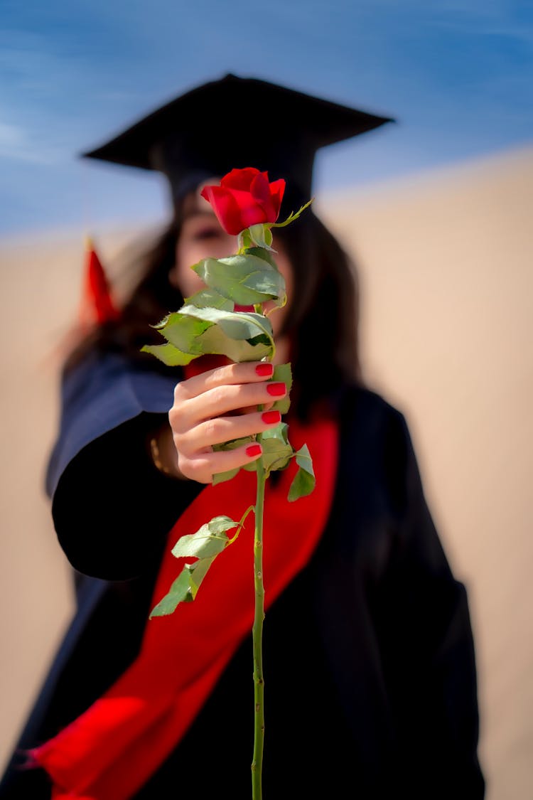 Graduate Student Holding A Flower 