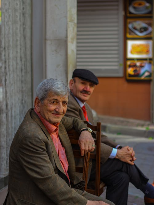 Elderly Men Sitting on Wooden Chairs