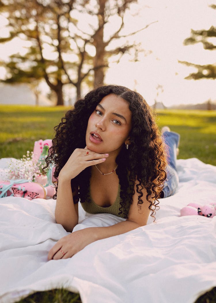 Young Woman Lying Down In A Park