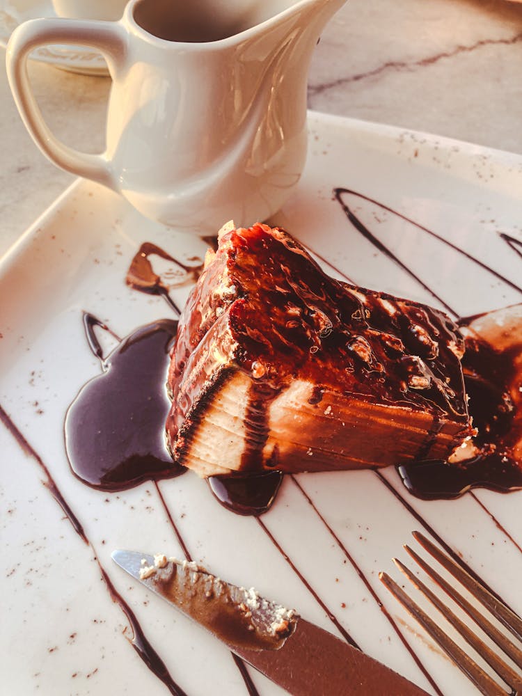 A Chocolate Cheesecake On A Ceramic Plate