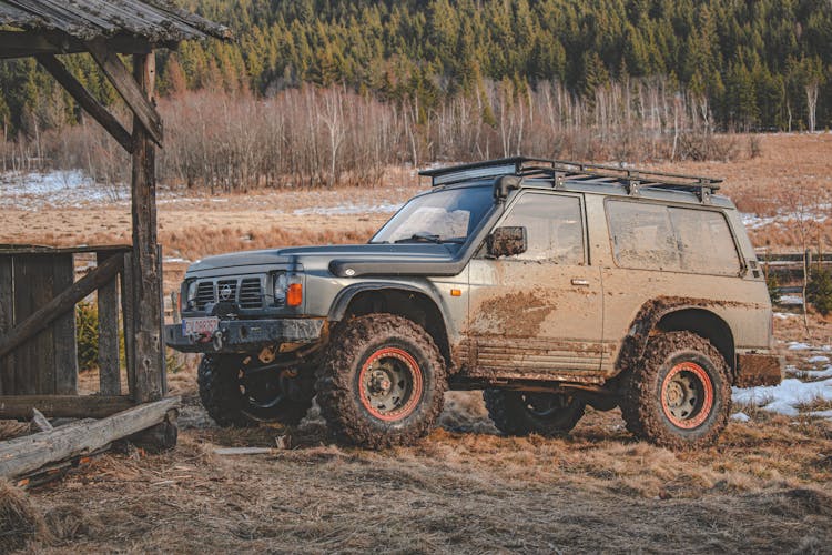 Muddy Truck Beside A Shack 