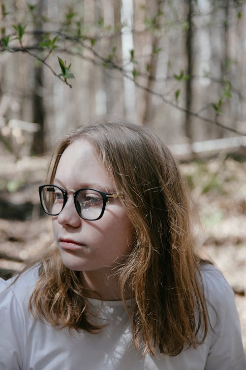 Young Girl in White Shirt Wearing Black Framed Eyeglasses