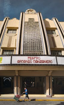 Low angle view of Teatro Armando Manzanero in Mérida with person walking by