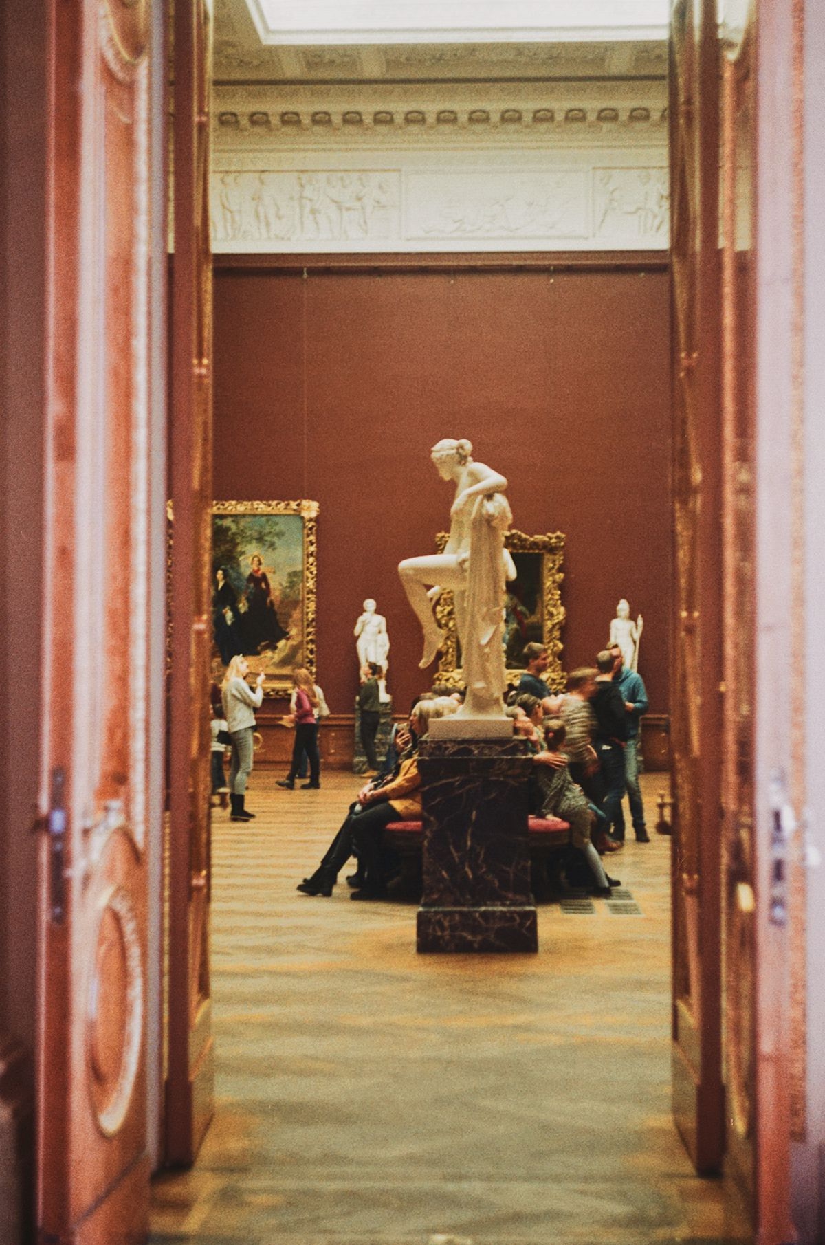 Visitors gathered before a celebrated portrait