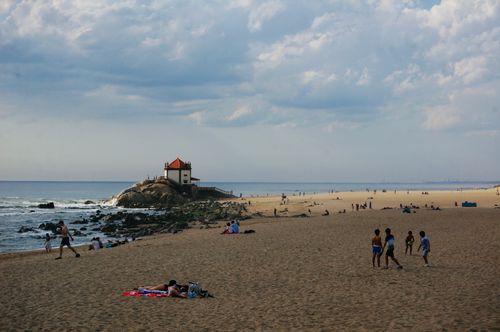 Free People enjoy a relaxing day at the beach near Capela do Senhor da Pedra in Arcozelo. Stock Photo