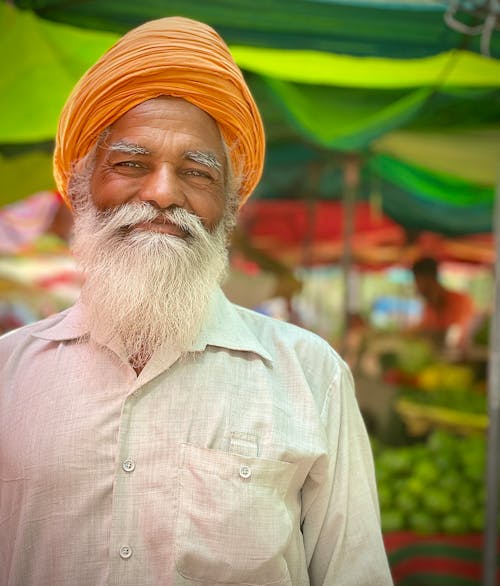 Close-up Photo of an Elderly Man in an Orange Pagri 