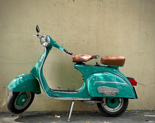 Green Vintage Scooter Near a Green Wall