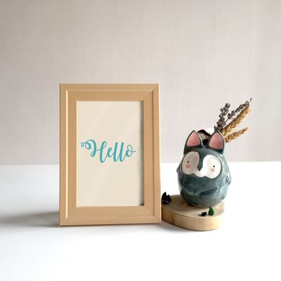 Framed calligraphy print on a shelf, photo by Stephanie Ho on Pexels