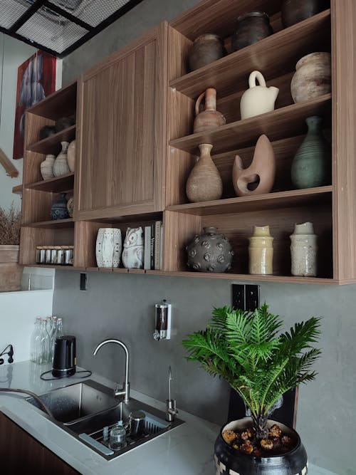 Collection of Vases on Wooden Drawers on Top of Kitchen Sink 