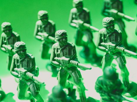 Detailed view of green plastic toy soldiers lined up in formation, symbolizing strategy and teamwork.