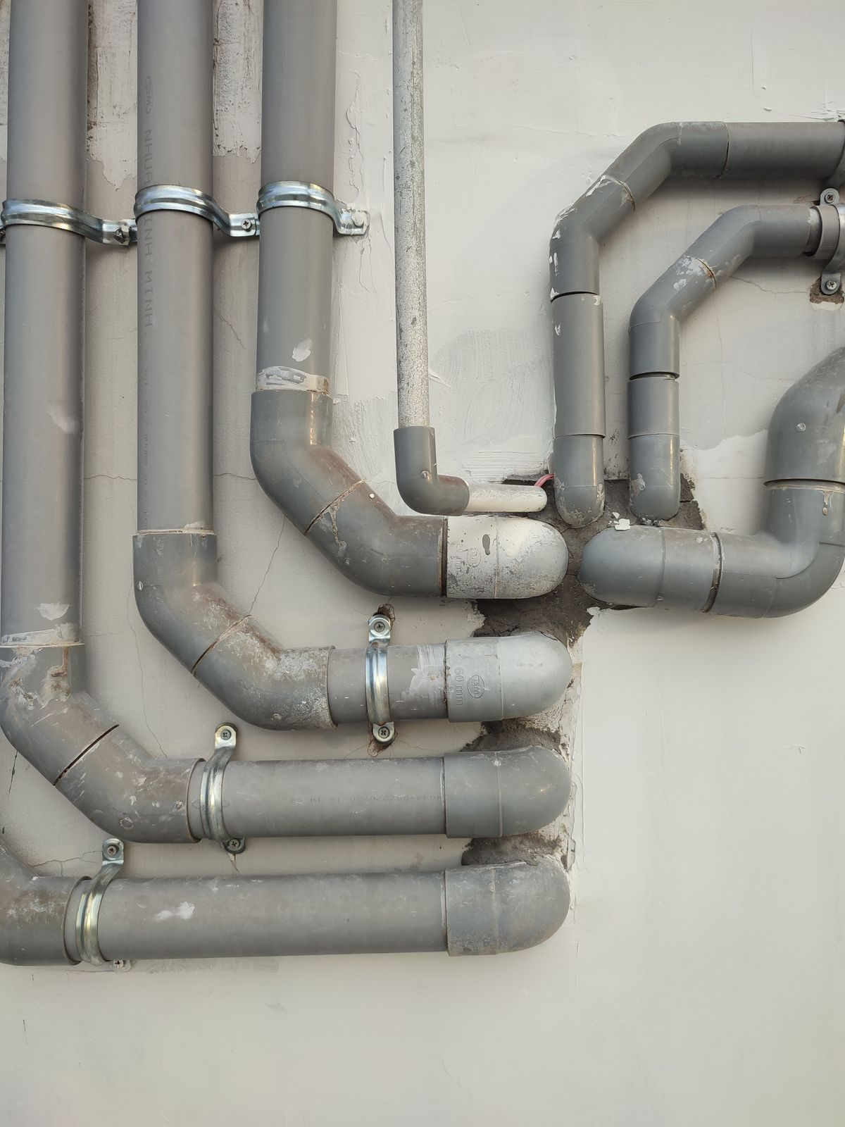 Metal pipework running across a wall