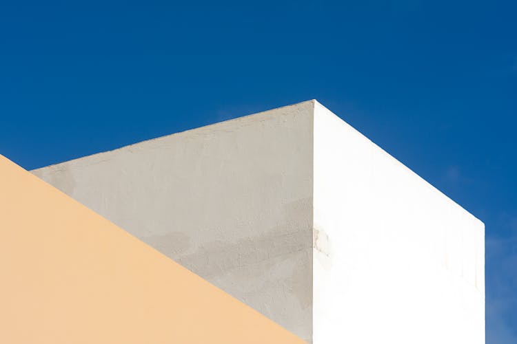 White Geometric Buildings On Blue Sky