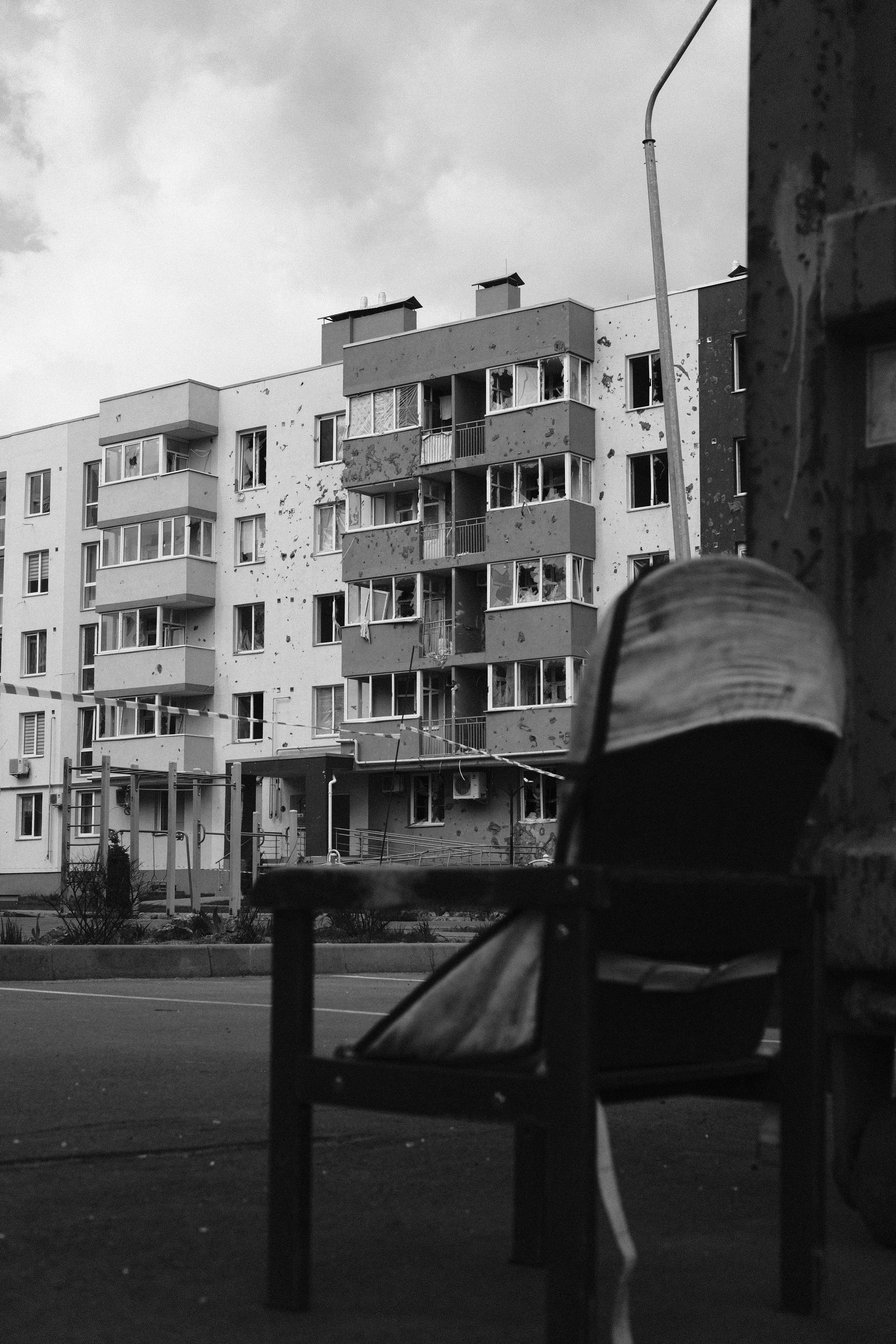 Bucha — damaged buildings frame a decayed street.