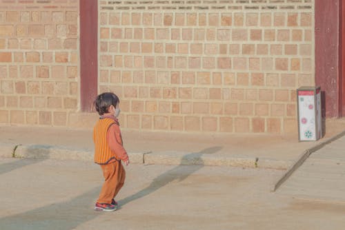 Child walking near a Wall 