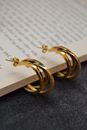 Gold Cross Pendant Necklace on Book Page
