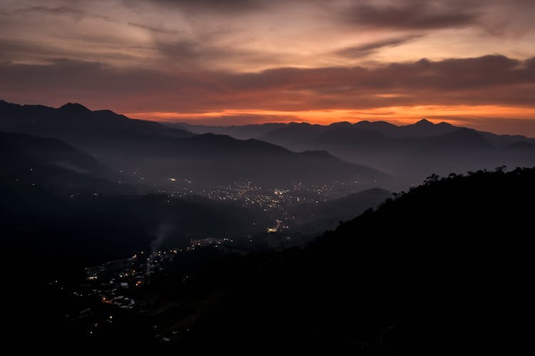 Clouds At Sunset Over Town In Valley