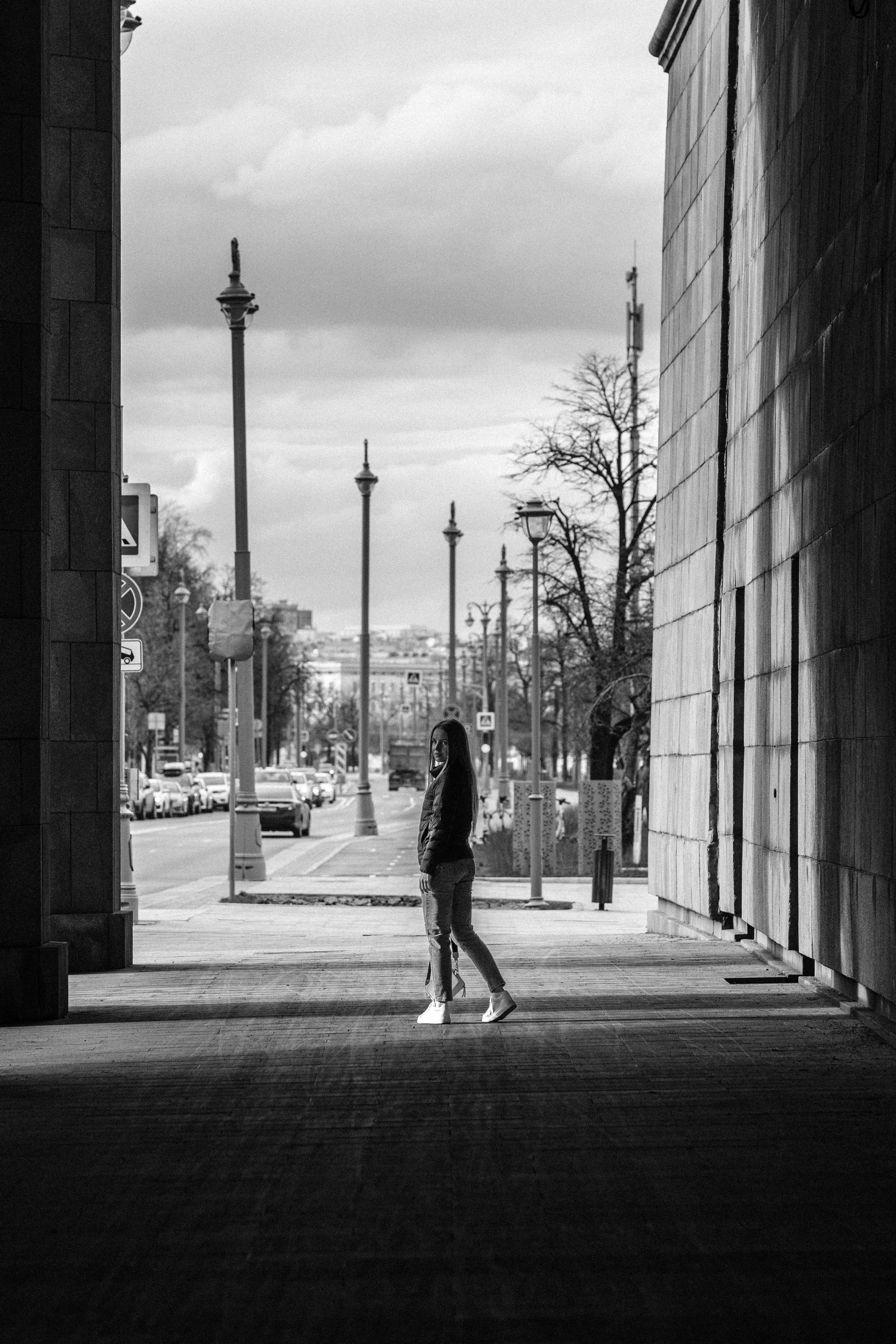 Grayscale Photo of Woman Standing on the Sidewalk · Free Stock Photo