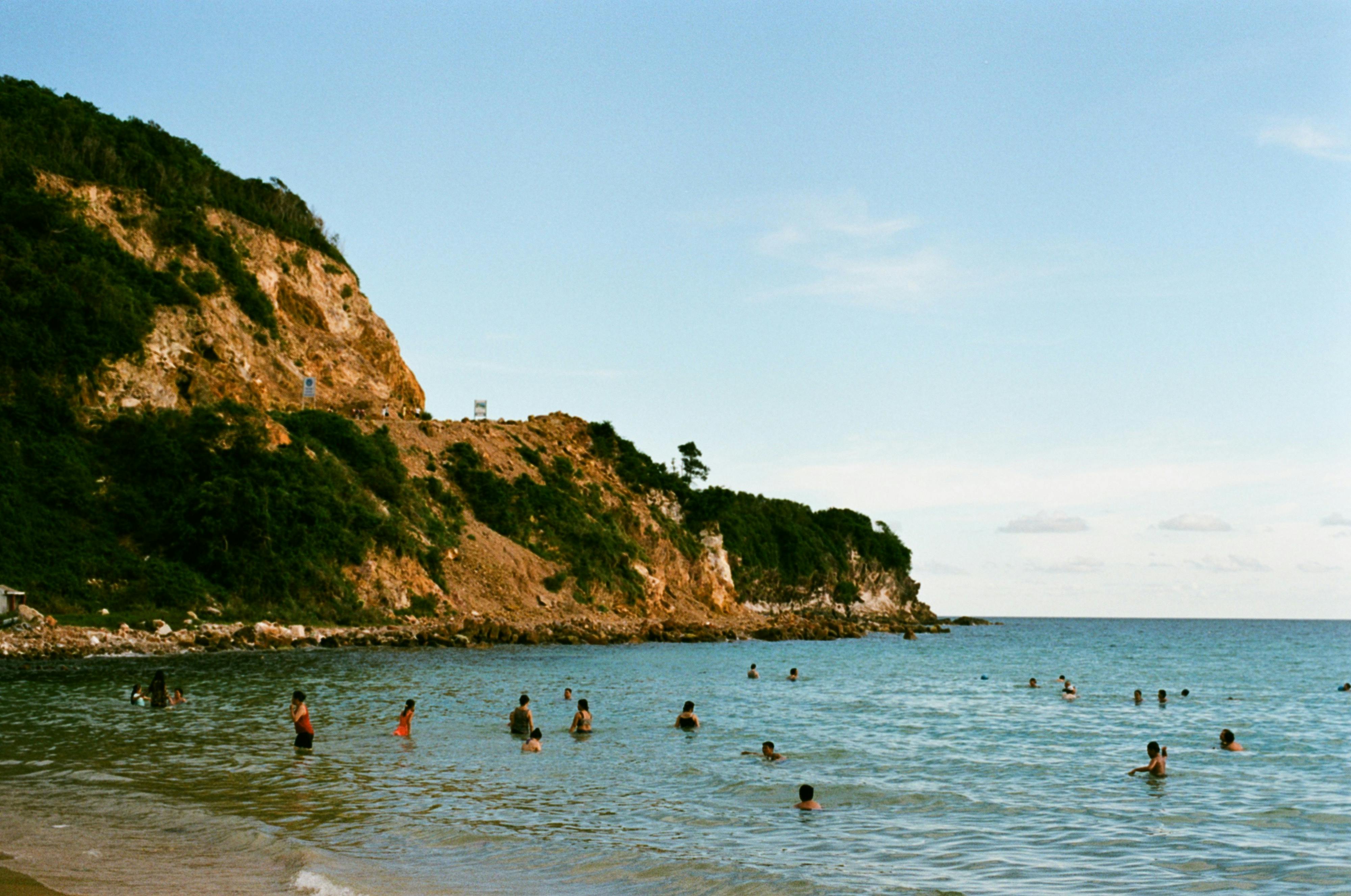 people swimming on the beach