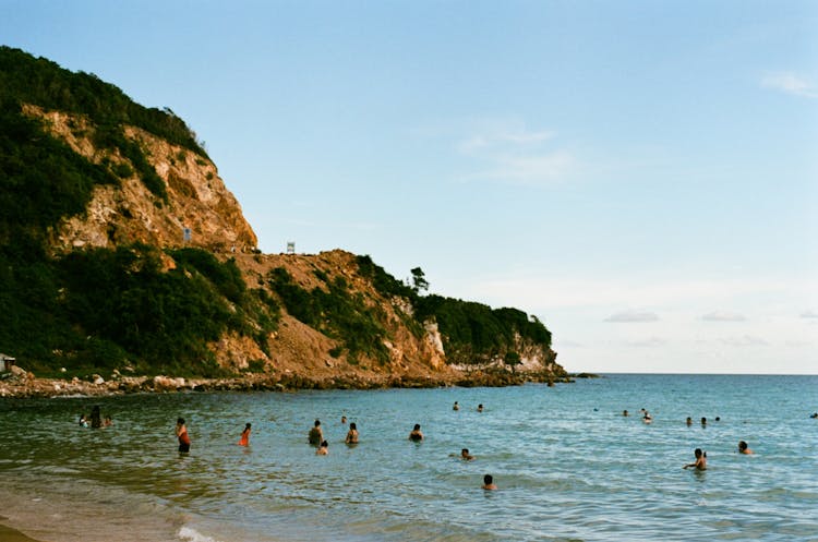 People Swimming On The Beach