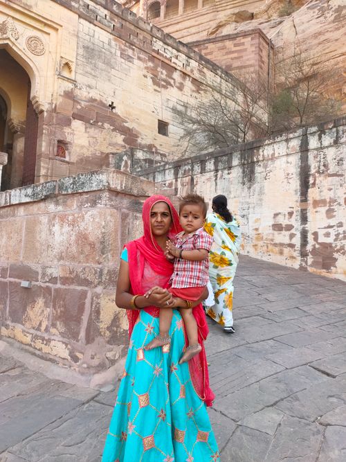 Free A mother and son in vibrant traditional Indian clothing at a historic site. Stock Photo