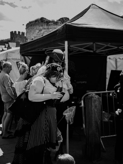 Free Dynamic black and white photo of people at a lively outdoor street festival. Stock Photo