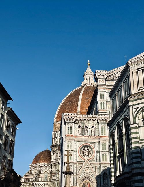 Free A stunning view of Florence Cathedral's dome, showcasing its architectural grandeur on a clear day in Florence, Italy. Stock Photo