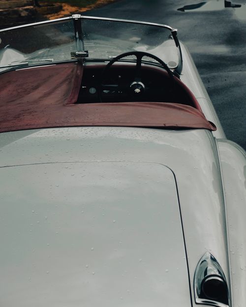 Free Close-up of a vintage convertible car with raindrops, highlighting classic design. Stock Photo