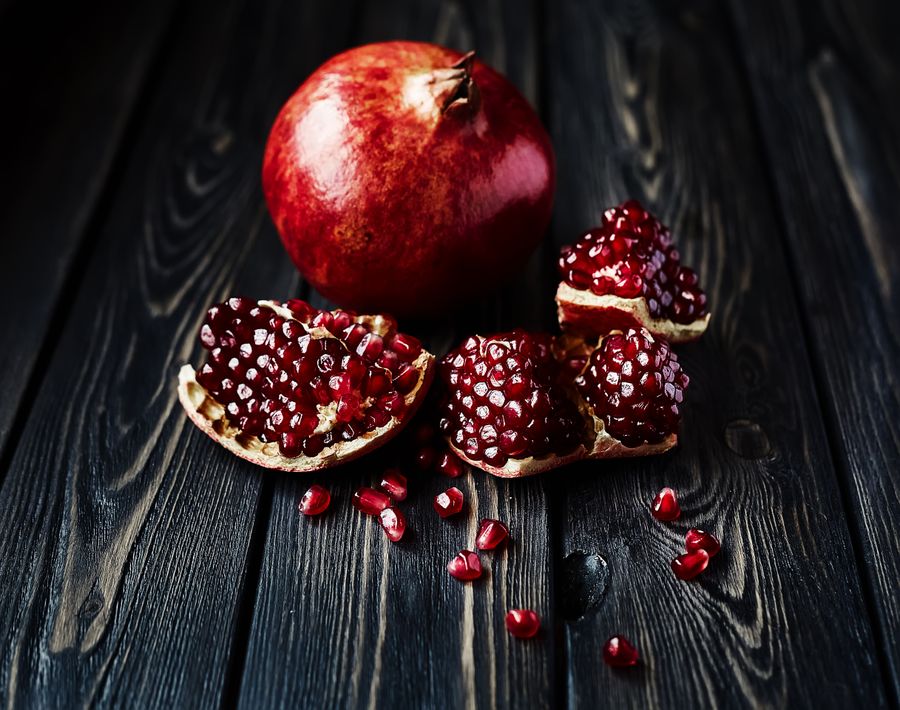 Pomegranate on dark wood