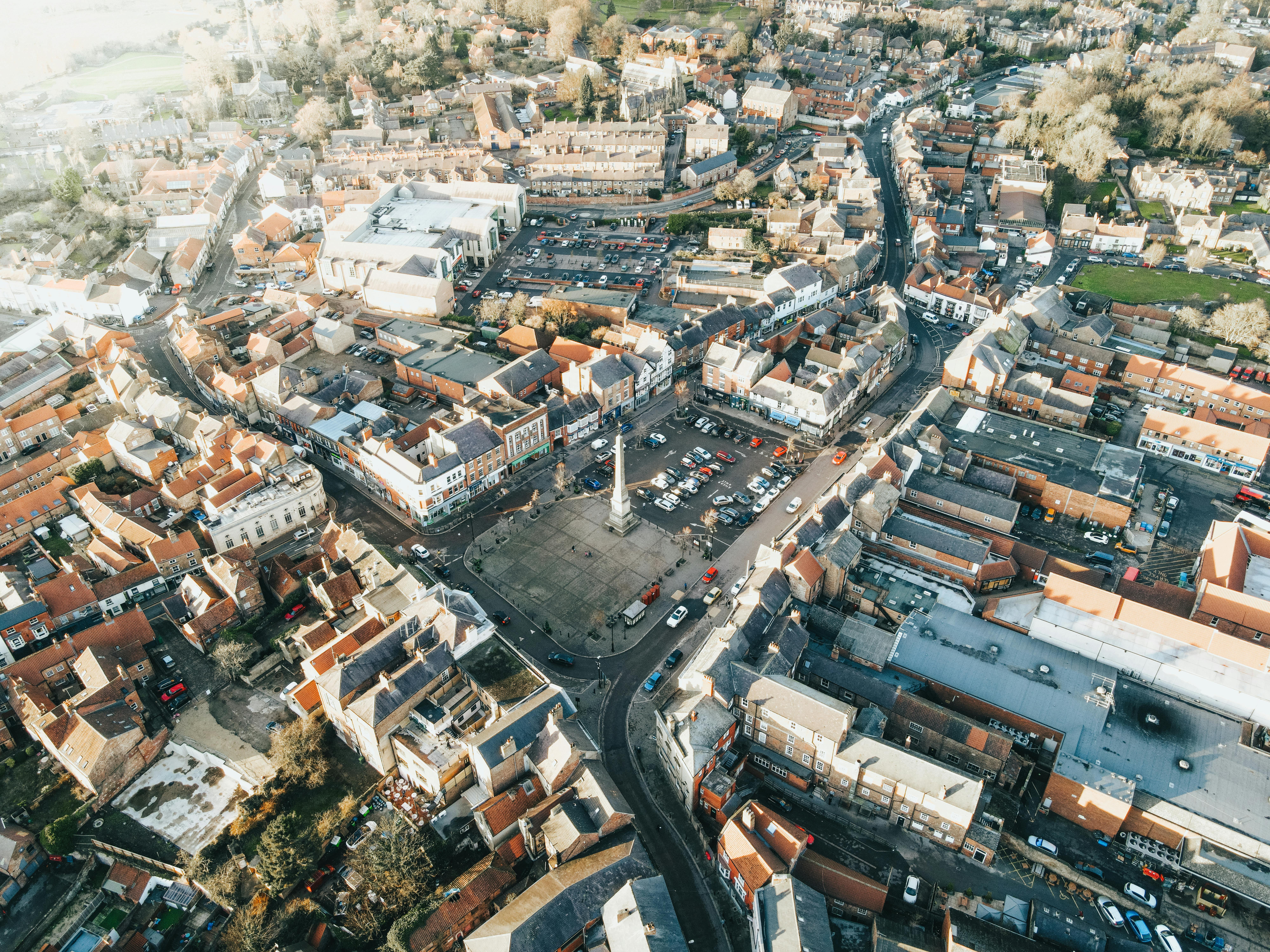 High-angle aerial view of a historic market town with old buildings and streets in the UK.