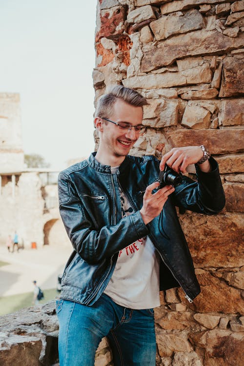 Man in Black Leather Jacket Holding a Camera