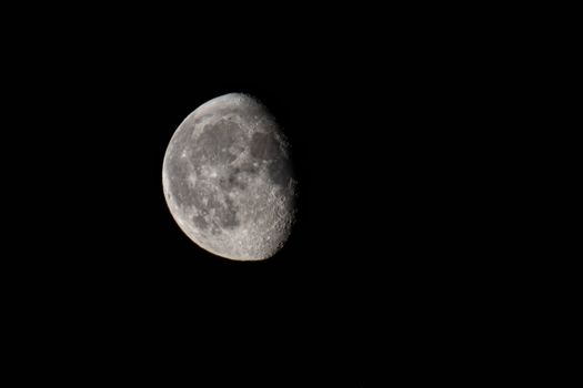 High-resolution close-up photo of the moon's surface against a dark night sky.
