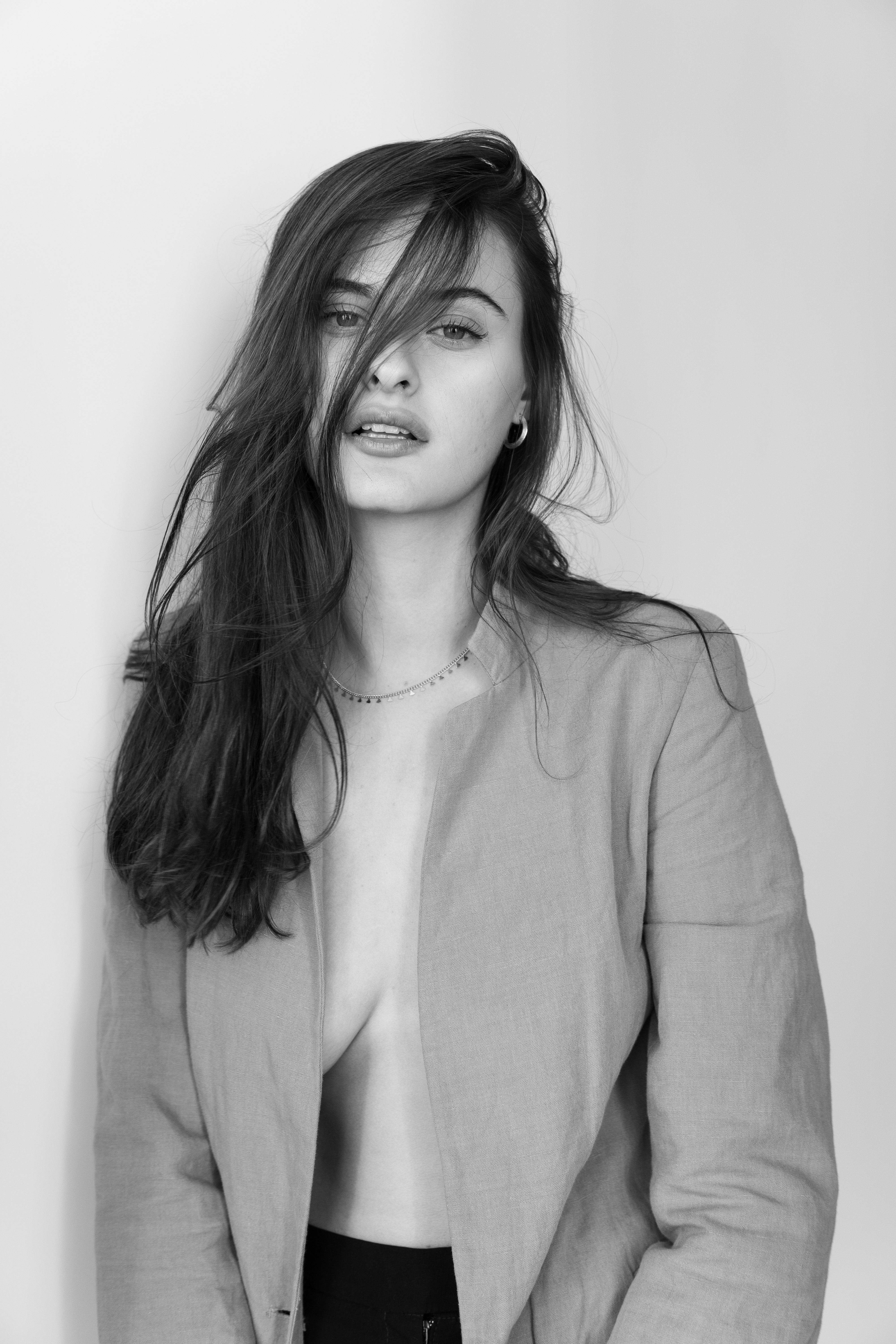 Striking black and white portrait of a woman with long hair, embodying elegance and grace.