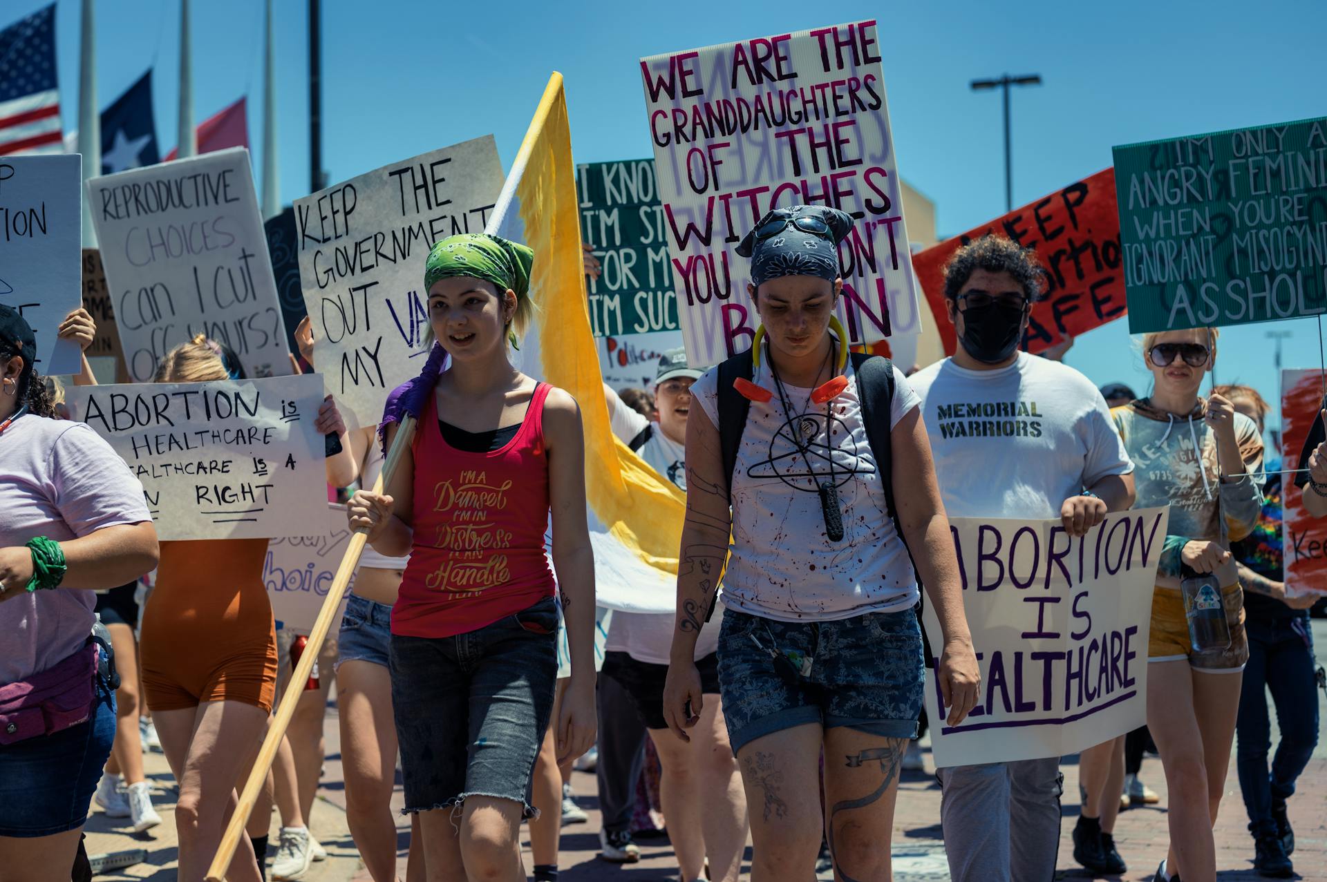 A diverse group of activists holding signs during a reproductive rights march.