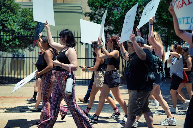 People Protesting And Holding Placards