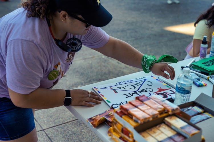 A Woman Near A Table Campaigning